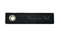 NICI Message Schlüsselanhänger mit Spruch, Variante: "Keys to hell" Schlüsselband schwarz mit grauer Schrift