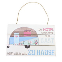 Holzschild mit Spruch: Im Hotel sind wir nur Gast. Hier sind wir Zuhause.